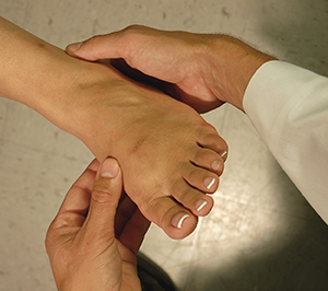 Closeup of hands holding female foot.