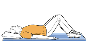 Man lying on floor with knees bent and feet flat on floor.