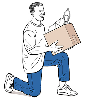 Side view of man on one knee lifting box.