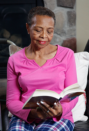 Woman sitting, reading.