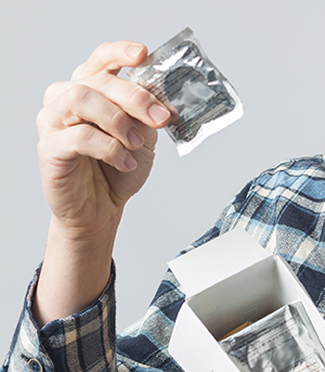 Man holding box of condoms.